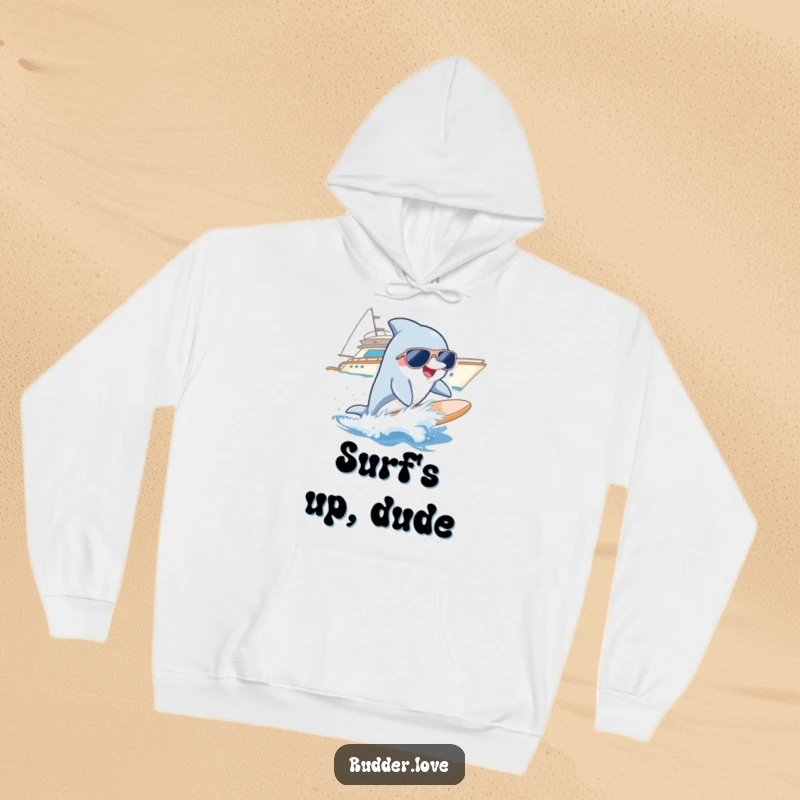 Funny hoodie with a smiling dolphin wearing sunglasses, surfing a wave near a yacht, offering cozy cool vibes.